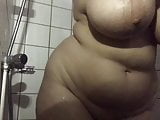 Horny big tits babe taking shower