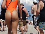 Girl in orange swimsuit thong